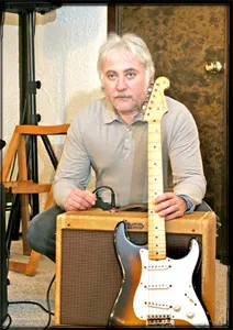 Jan seated with a 1957 Stratocaster and a 1957 Fender Deluxe amp